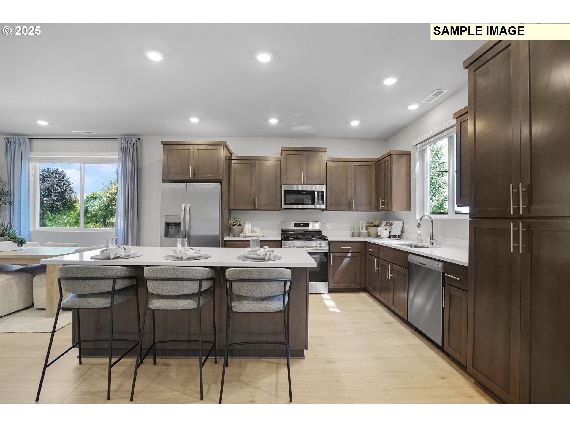 33375 Southwest Rokin Way Scappoose, OR 97056 - Photo 5 of 32 a kitchen with kitchen island granite countertop wooden floors and white cabinets