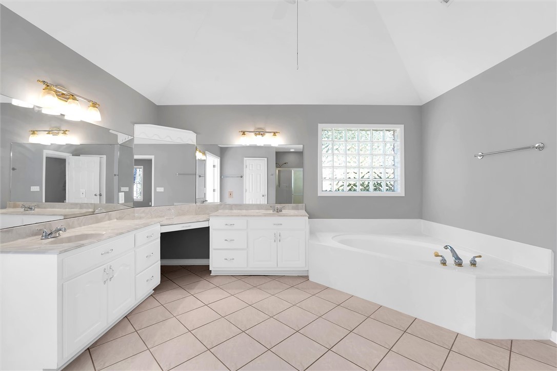204 Red Maple Way Clemson, SC 29631 - Photo 28 of 48 This spacious bathroom offers dual vanities, a large soaking tub, and tile flooring.