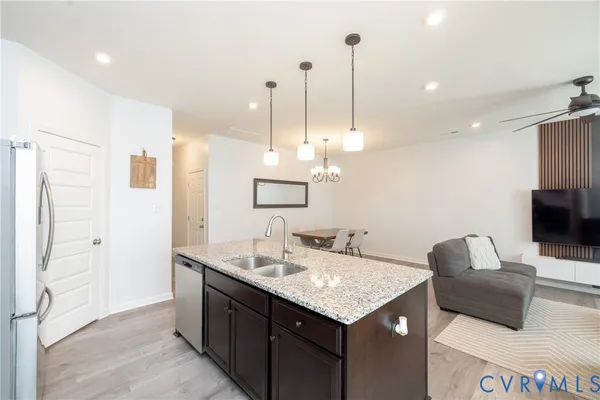a kitchen with a sink a counter space and stainless steel appliances