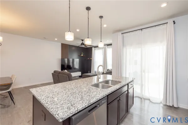 a kitchen with granite countertop cabinets and wooden floor
