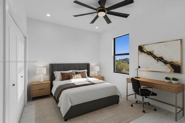a bedroom with a bed and a ceiling fan