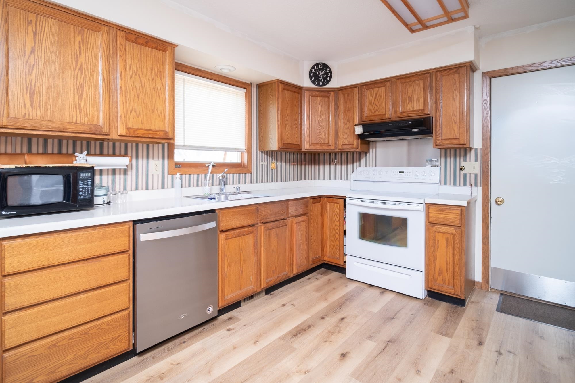 15767 Crowley Road Durand, IL 61024 - Photo 10 of 18 a kitchen with stainless steel appliances granite countertop a stove a sink and a microwave