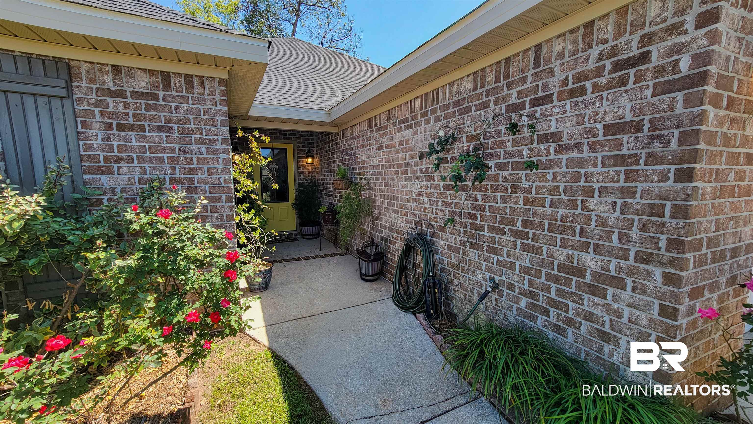 1304 Majesty Loop Foley, AL 36535 - Photo 34 of 44 Property entrance featuring brick siding and roof with shingles