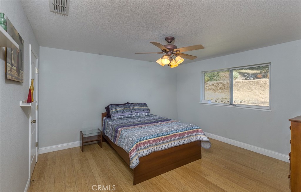 45315 Forest Ridge Drive Ahwahnee, CA 93601 - Photo 16 of 75 a bedroom with a bed and a window