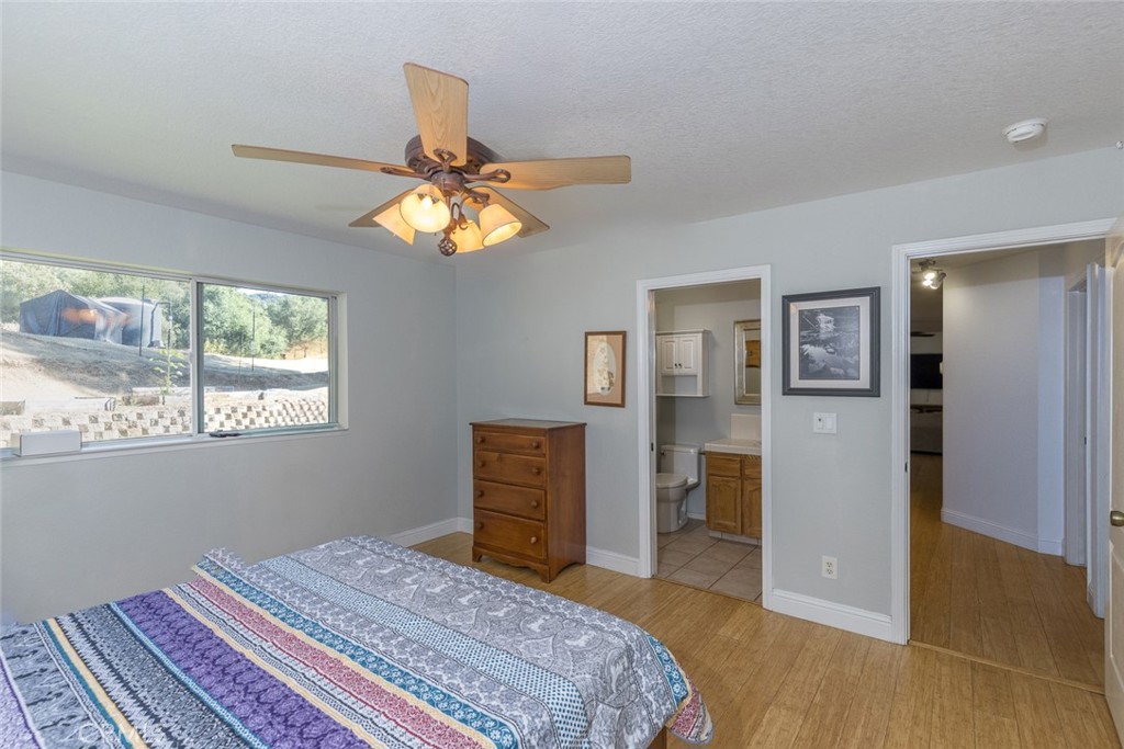 45315 Forest Ridge Drive Ahwahnee, CA 93601 - Photo 18 of 75 a bedroom with a bed and a chandelier