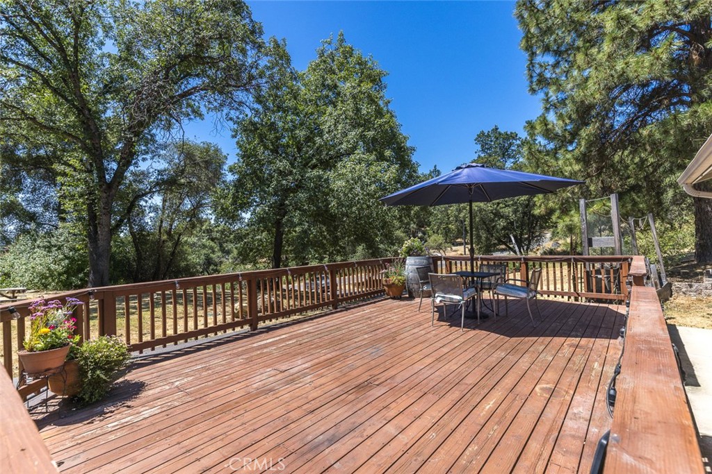 45315 Forest Ridge Drive Ahwahnee, CA 93601 - Photo 34 of 75 a view of balcony with outdoor seating and wooden floor