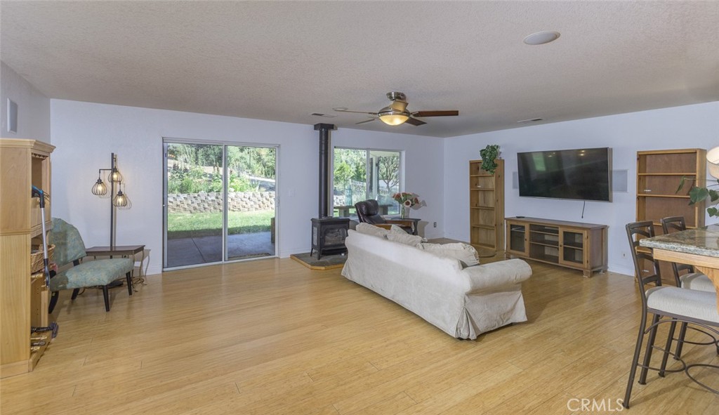 45315 Forest Ridge Drive Ahwahnee, CA 93601 - Photo 6 of 75 a living room with furniture a flat screen tv and a large window