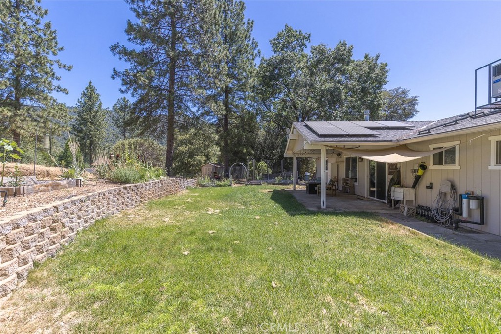 45315 Forest Ridge Drive Ahwahnee, CA 93601 - Photo 62 of 75 a view of a house with a yard patio and tree