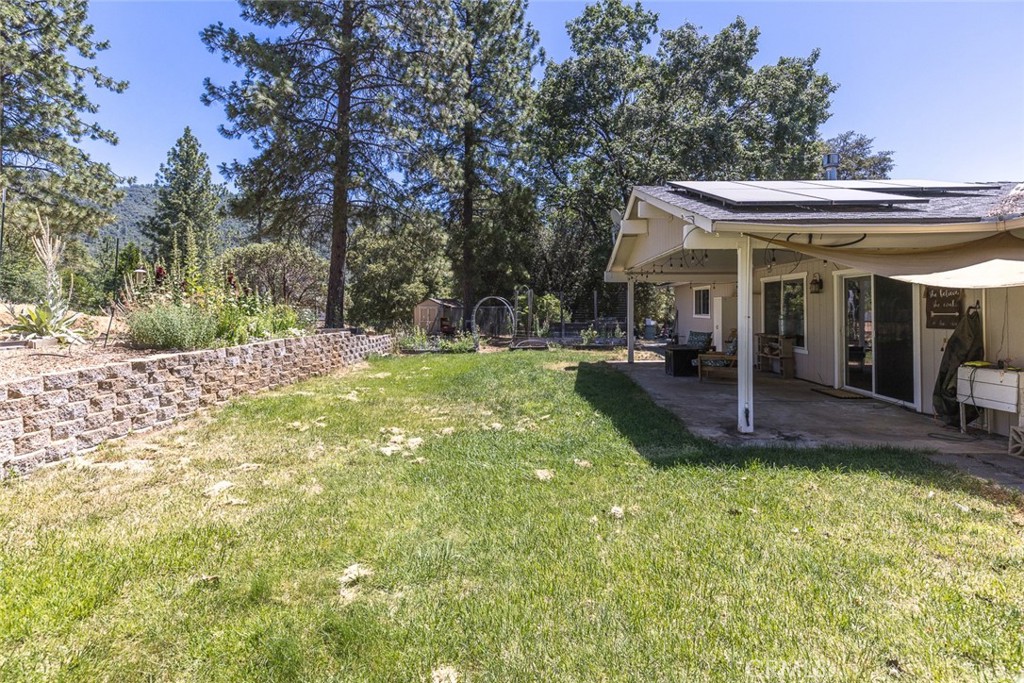 45315 Forest Ridge Drive Ahwahnee, CA 93601 - Photo 63 of 75 a view of a house with a big yard and large trees