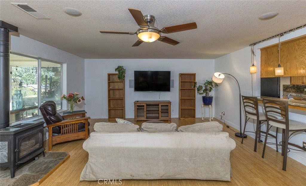 45315 Forest Ridge Drive Ahwahnee, CA 93601 - Photo 7 of 75 a bed room with furniture and a flat screen tv