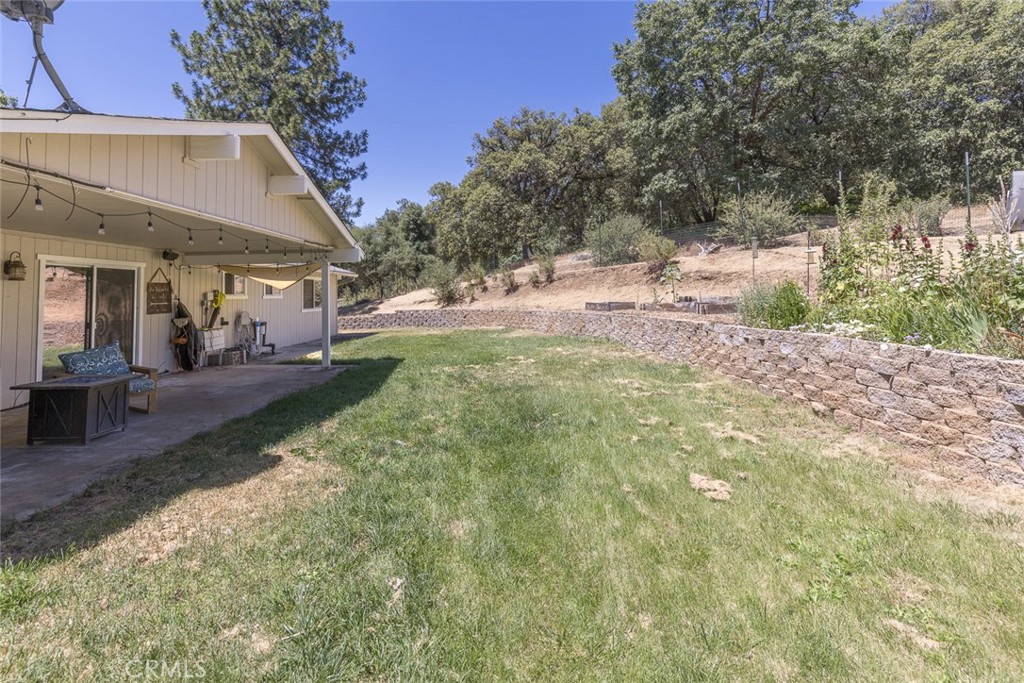 45315 Forest Ridge Drive Ahwahnee, CA 93601 - Photo 73 of 75 a view of a yard with plants and a bench