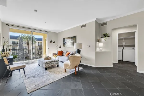 a living room with furniture rug and wooden floor