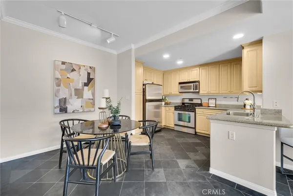 a kitchen with cabinets stainless steel appliances and wooden floor