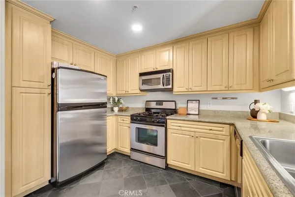 a kitchen with a refrigerator and table chair