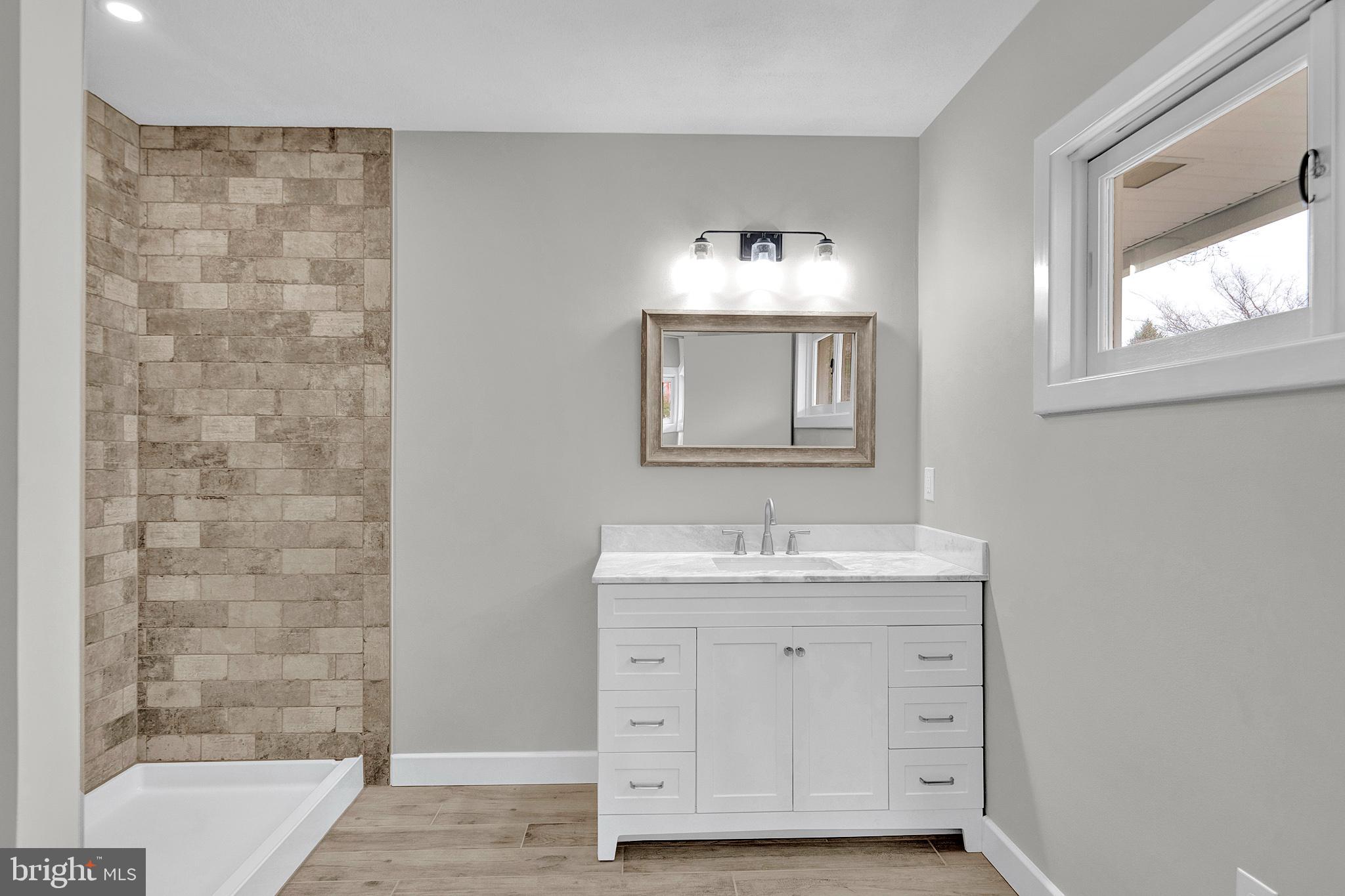 412 Washington Crossing Pennington Road Titusville, NJ 08560 - Photo 18 of 38 a bathroom with a double vanity sink a mirror and a bathtub