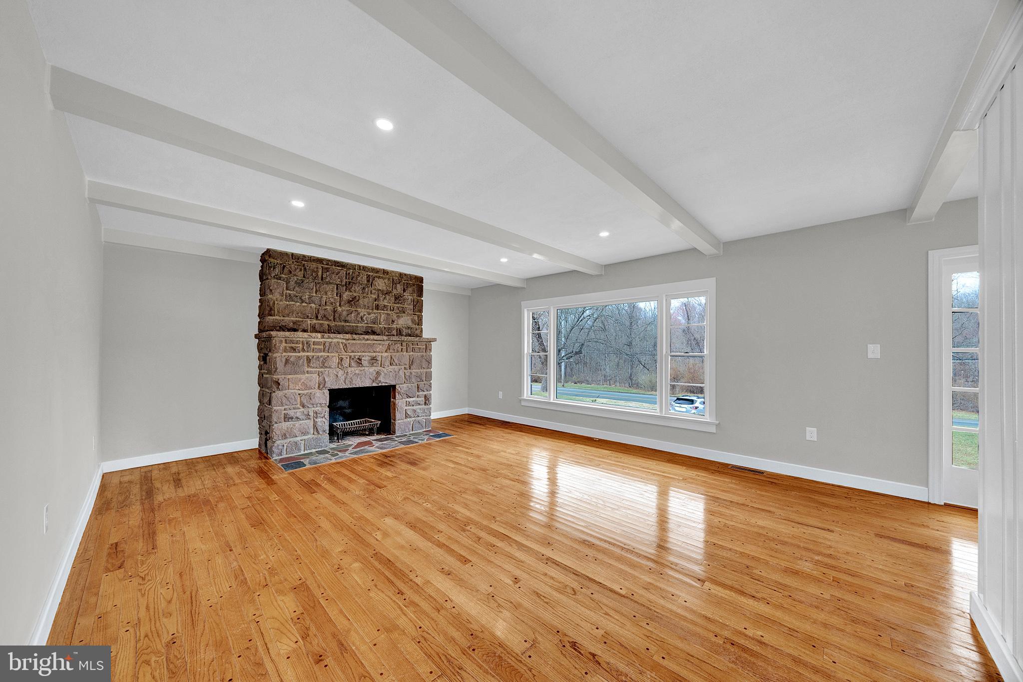 412 Washington Crossing Pennington Road Titusville, NJ 08560 - Photo 4 of 38 a view of empty room with wooden floor and fireplace