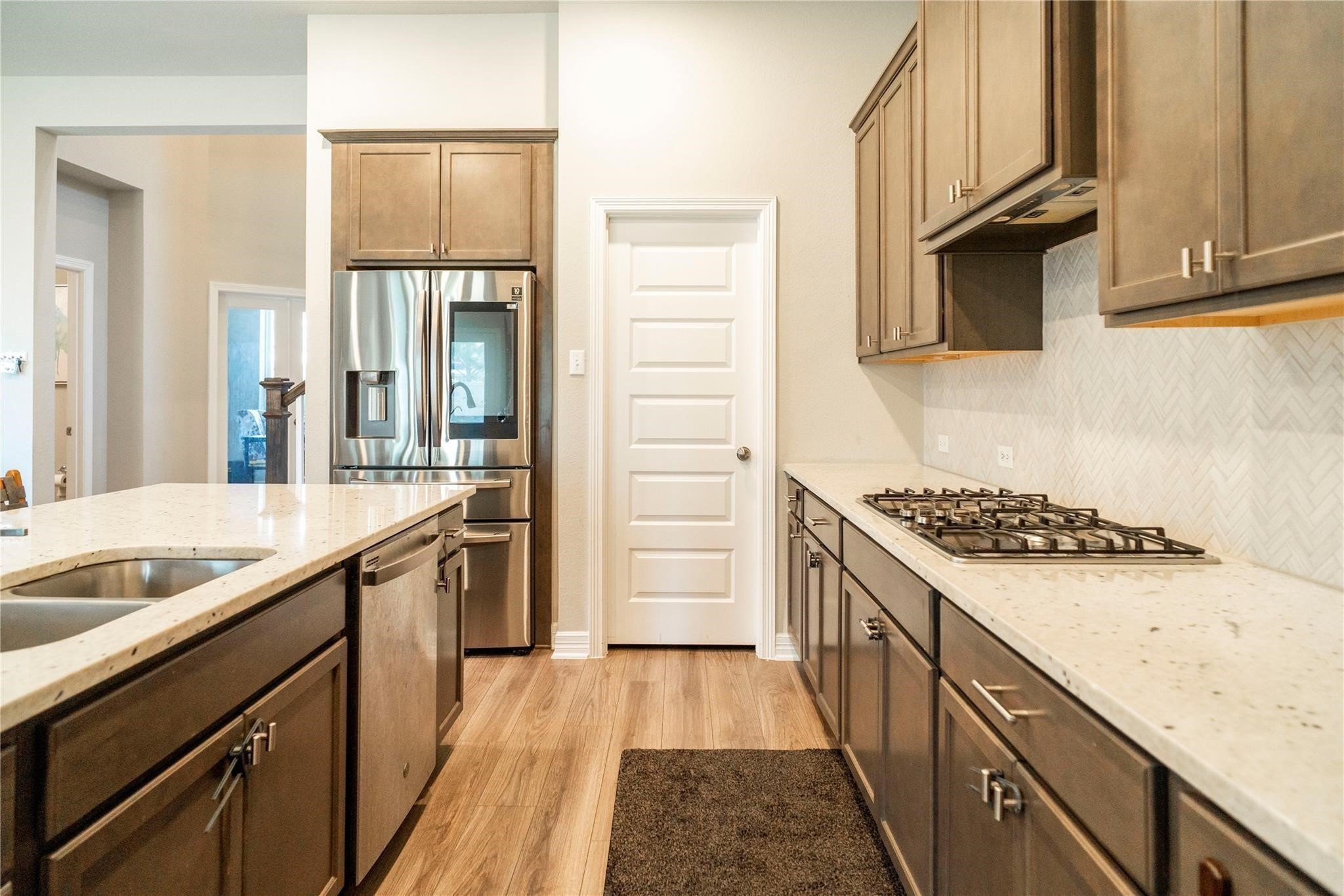29023 Laurel Grove Lane Fulshear, TX 77441 - Photo 13 of 42 a kitchen with granite countertop a sink stove and cabinets