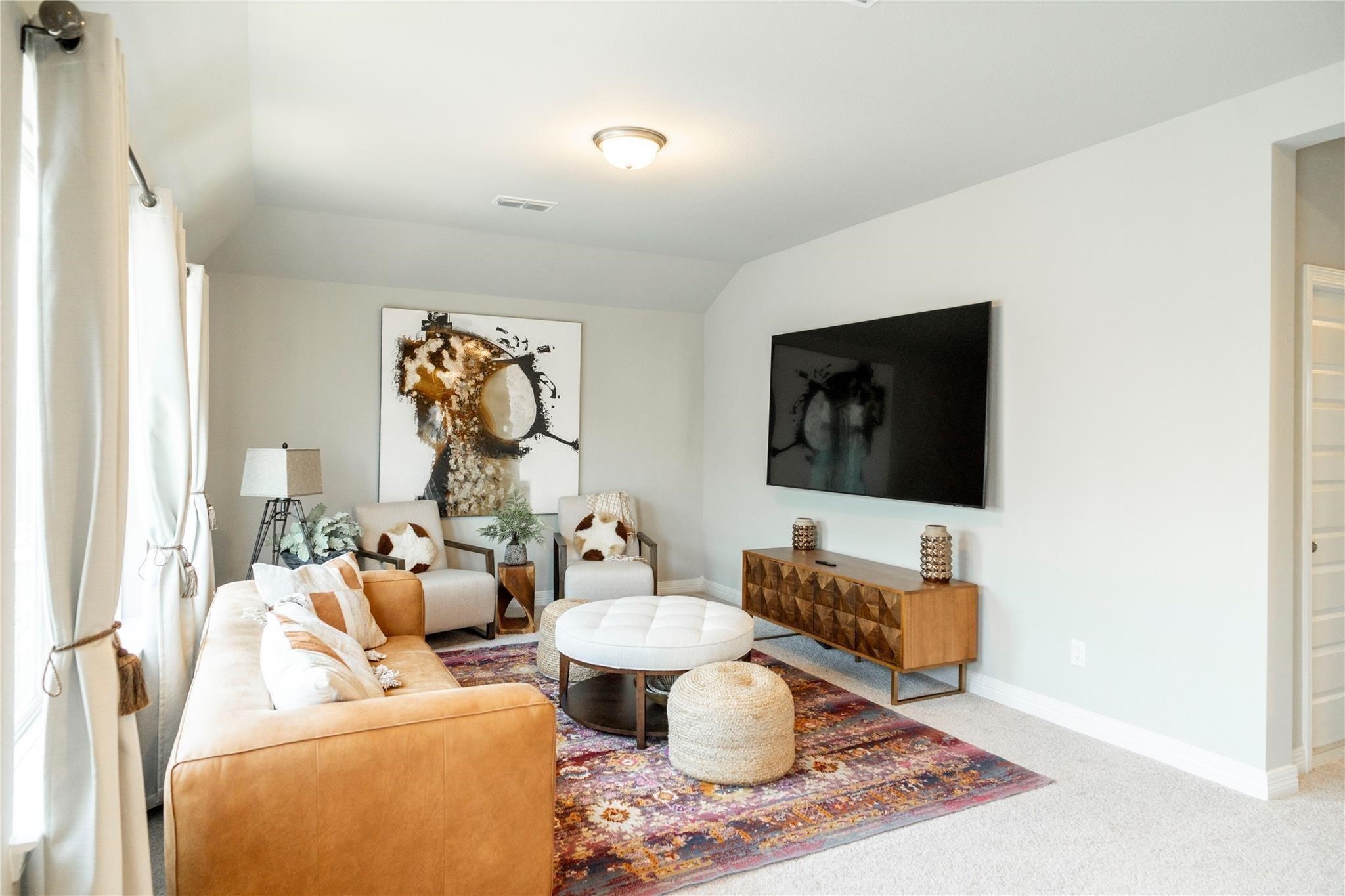 29023 Laurel Grove Lane Fulshear, TX 77441 - Photo 17 of 42 a living room with furniture a flat screen tv and a window