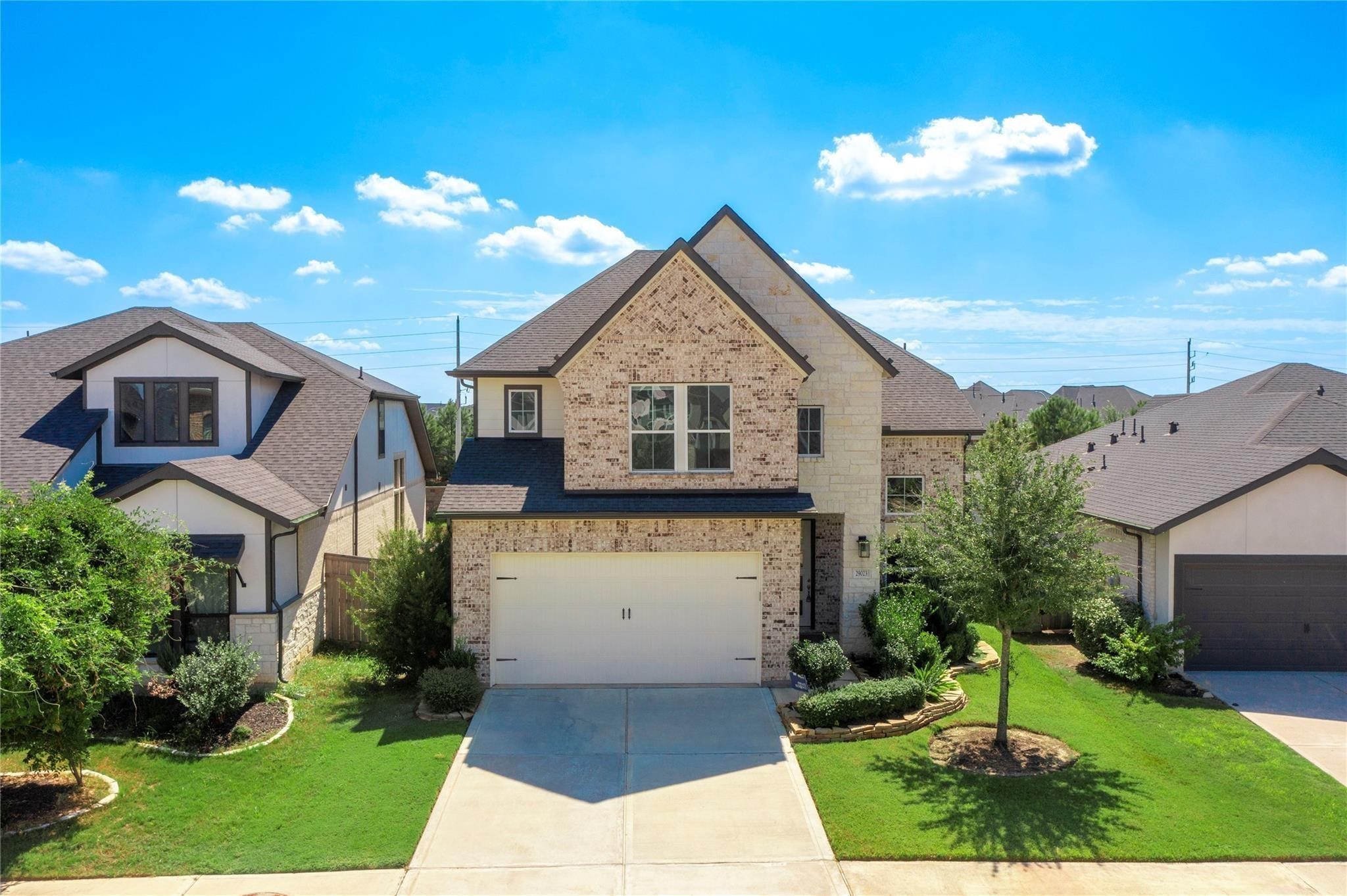 29023 Laurel Grove Lane Fulshear, TX 77441 - Photo 2 of 42 a front view of a house with a garden and yard
