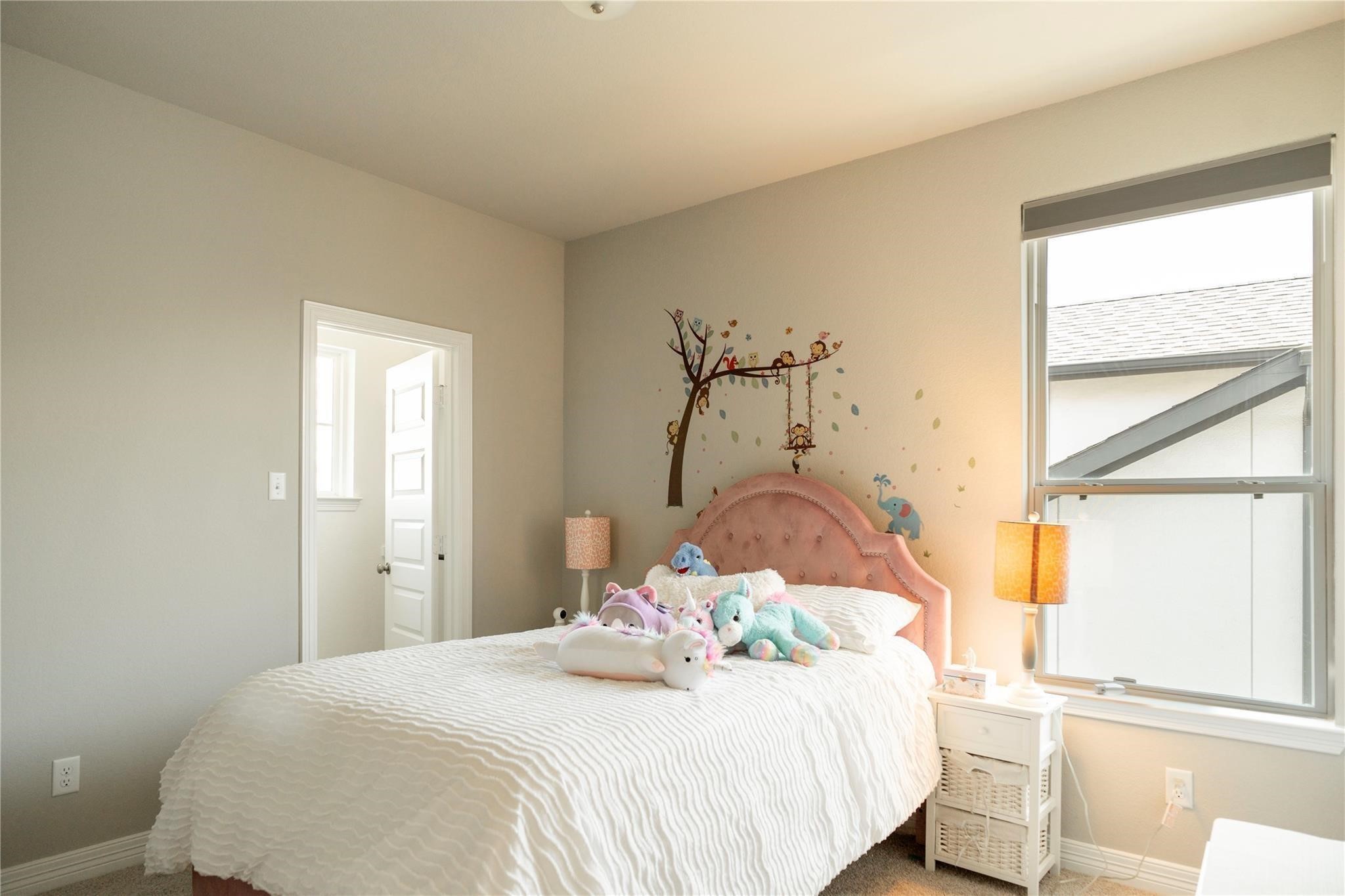 29023 Laurel Grove Lane Fulshear, TX 77441 - Photo 25 of 42 a bedroom with a bed and a window