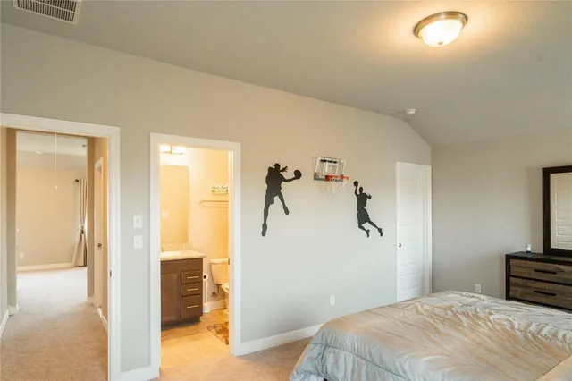 a bedroom with a bed and a view of bathroom