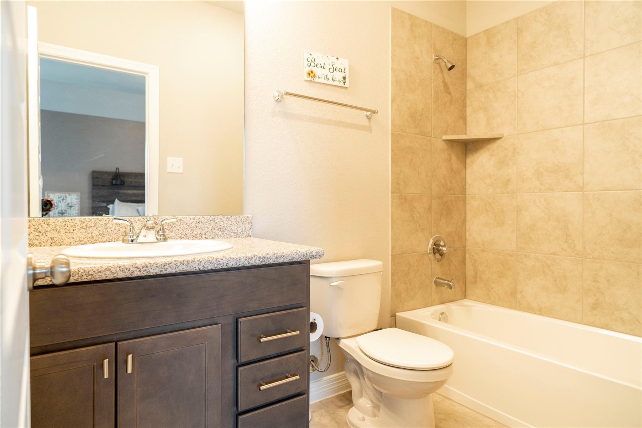 29023 Laurel Grove Lane Fulshear, TX 77441 - Photo 33 of 42 a bathroom with a granite countertop sink toilet and shower