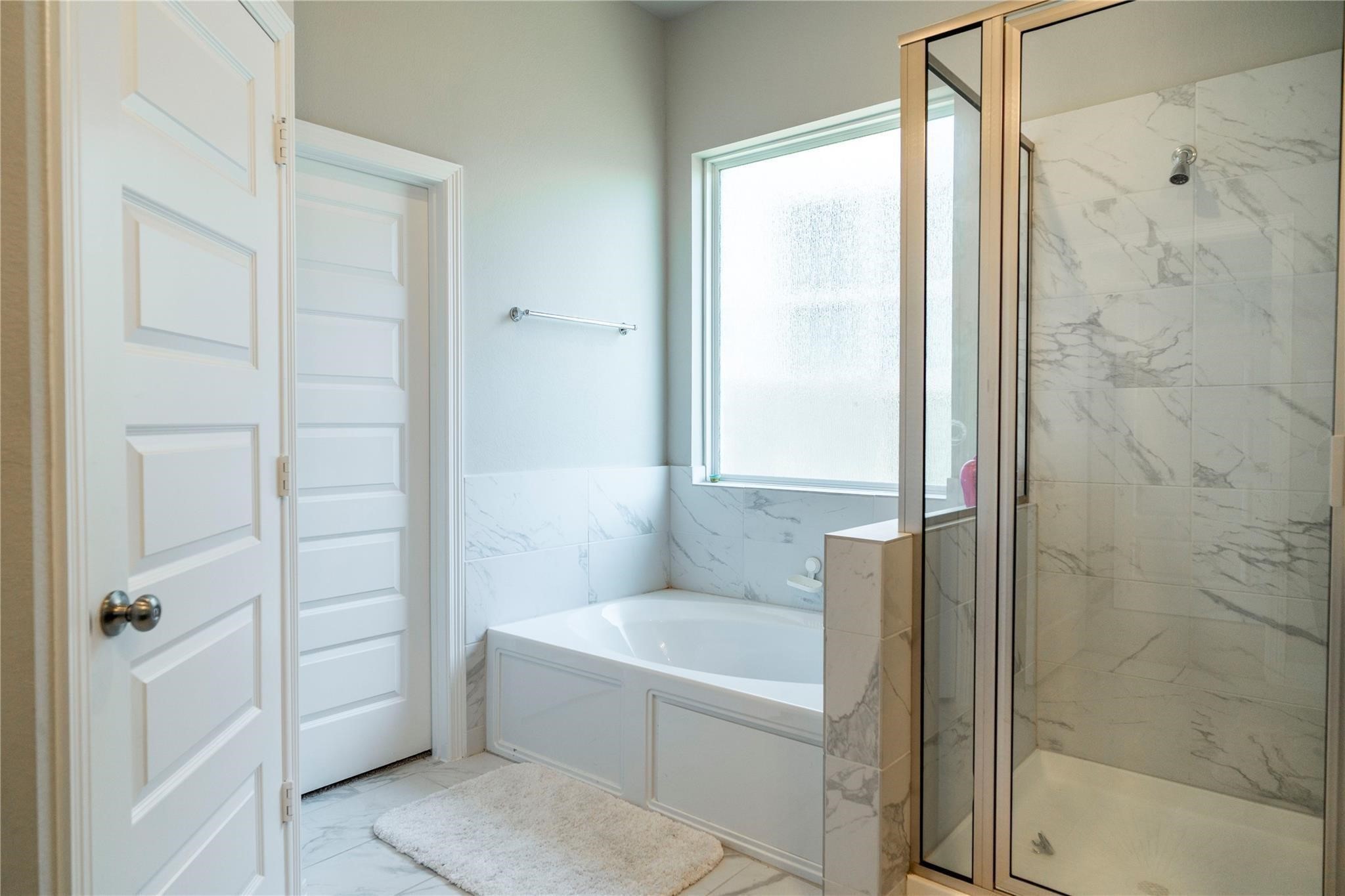 29023 Laurel Grove Lane Fulshear, TX 77441 - Photo 35 of 42 a bathroom with a tub and shower