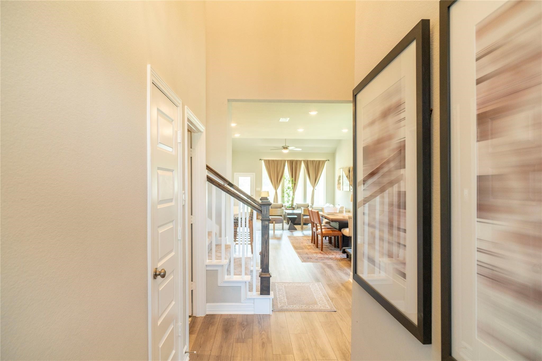 29023 Laurel Grove Lane Fulshear, TX 77441 - Photo 5 of 42 a view of a hallway with wooden floor and staircase