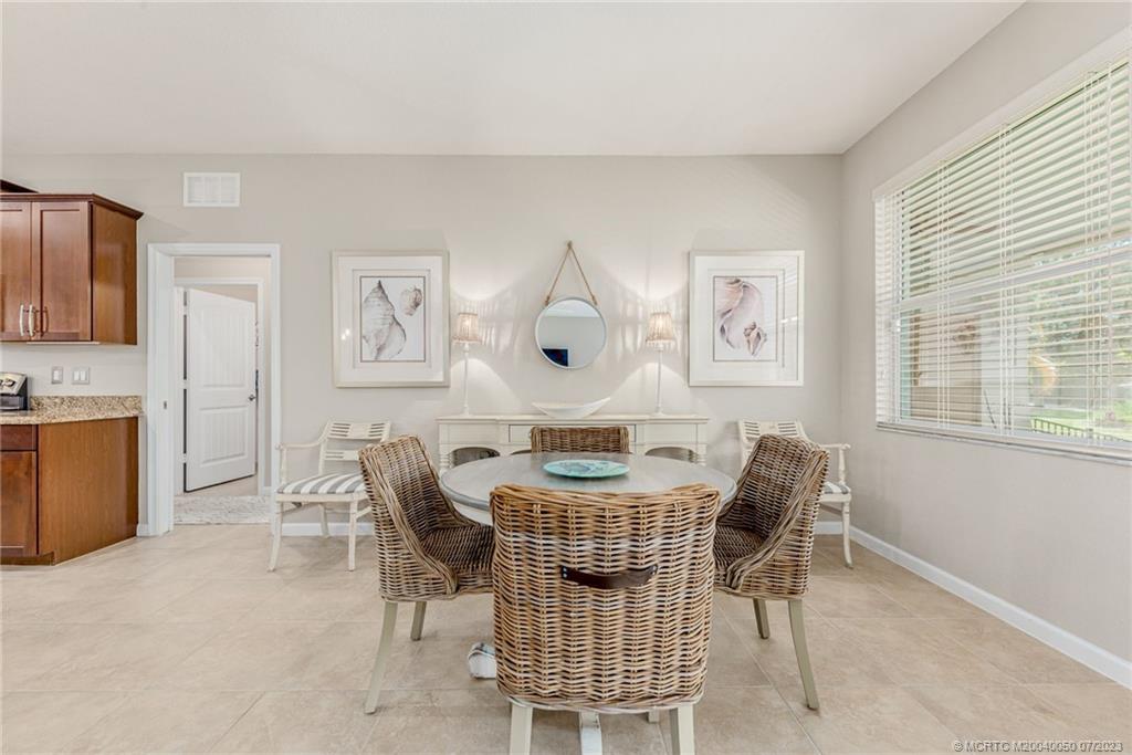 2185 Northwest Dalea Way Stuart, FL 34994 - Photo 12 of 55 a dining room with furniture and window