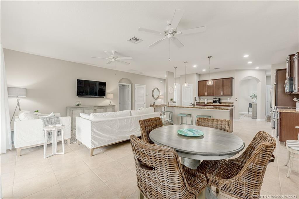 2185 Northwest Dalea Way Stuart, FL 34994 - Photo 13 of 55 a dining room with furniture and a kitchen view