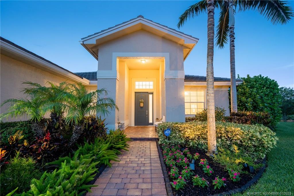 2185 Northwest Dalea Way Stuart, FL 34994 - Photo 2 of 55 a front view of a house with garden