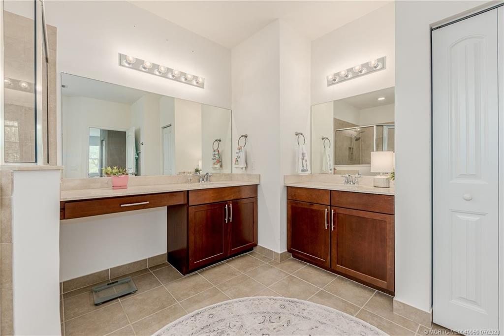 2185 Northwest Dalea Way Stuart, FL 34994 - Photo 21 of 55 a spacious bathroom with a granite countertop sink and a mirror
