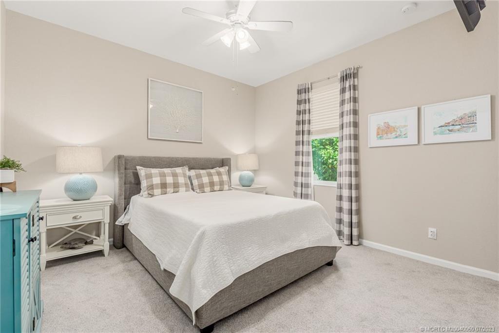 2185 Northwest Dalea Way Stuart, FL 34994 - Photo 23 of 55 a bedroom with a bed and a window
