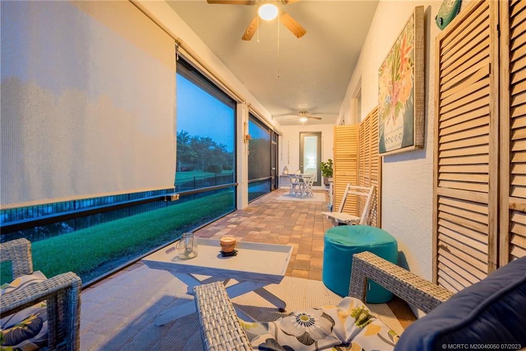 2185 Northwest Dalea Way Stuart, FL 34994 - Photo 27 of 55 a view of a patio with table and chairs with wooden floor and fence
