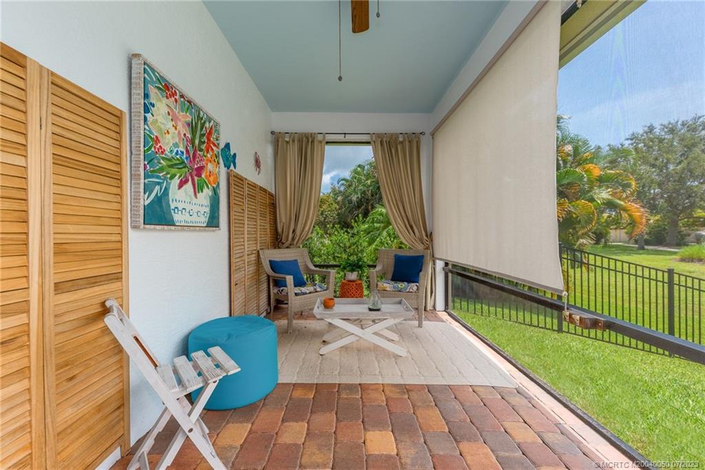 2185 Northwest Dalea Way Stuart, FL 34994 - Photo 28 of 55 a living room with patio furniture and a wooden floor