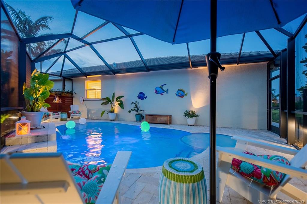 2185 Northwest Dalea Way Stuart, FL 34994 - Photo 29 of 55 a view of a dining room with furniture and a potted plant