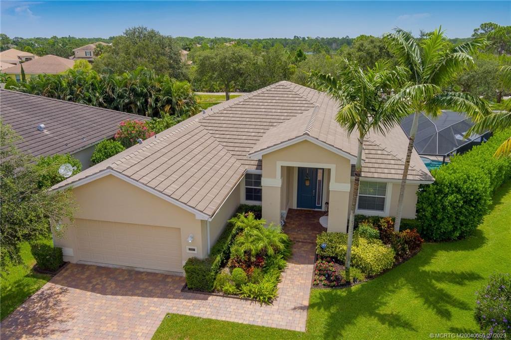 2185 Northwest Dalea Way Stuart, FL 34994 - Photo 3 of 55 a front view of a house with garden