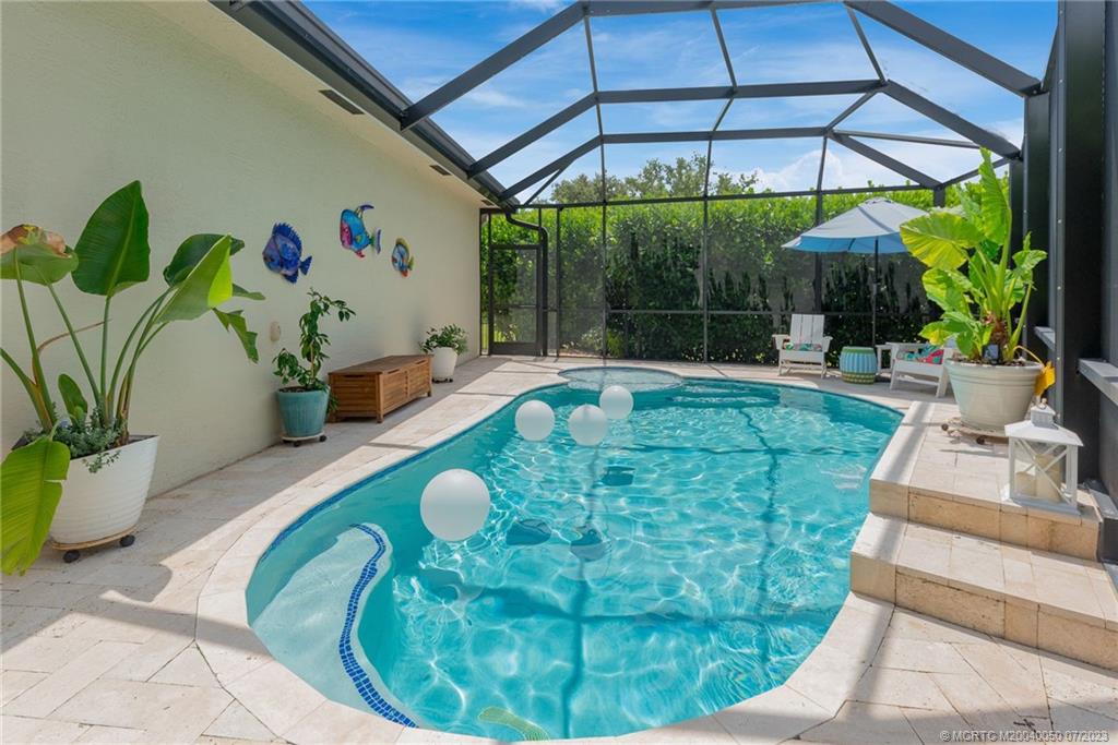 2185 Northwest Dalea Way Stuart, FL 34994 - Photo 34 of 55 a view of a swimming pool with a patio