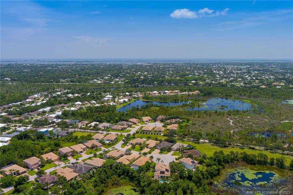 2185 Northwest Dalea Way Stuart, FL 34994 - Photo 41 of 55 an aerial view of residential houses with outdoor space and trees