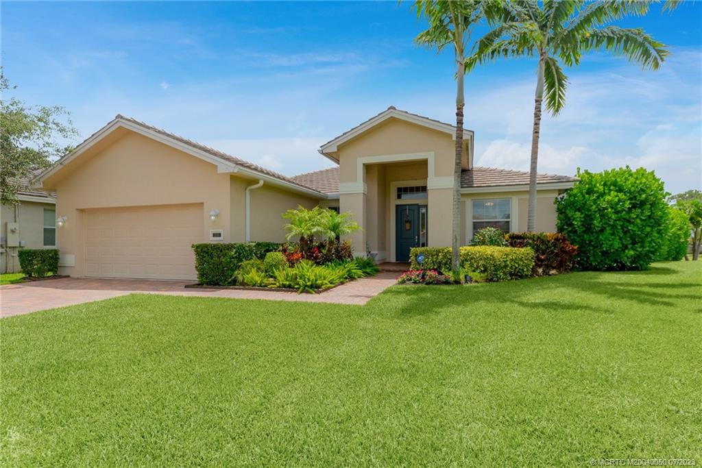2185 Northwest Dalea Way Stuart, FL 34994 - Photo 5 of 55 a front view of a house with a yard and garage