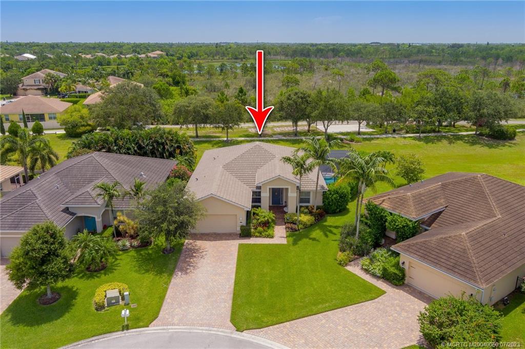 2185 Northwest Dalea Way Stuart, FL 34994 - Photo 53 of 55 an aerial view of a house with swimming pool and garden