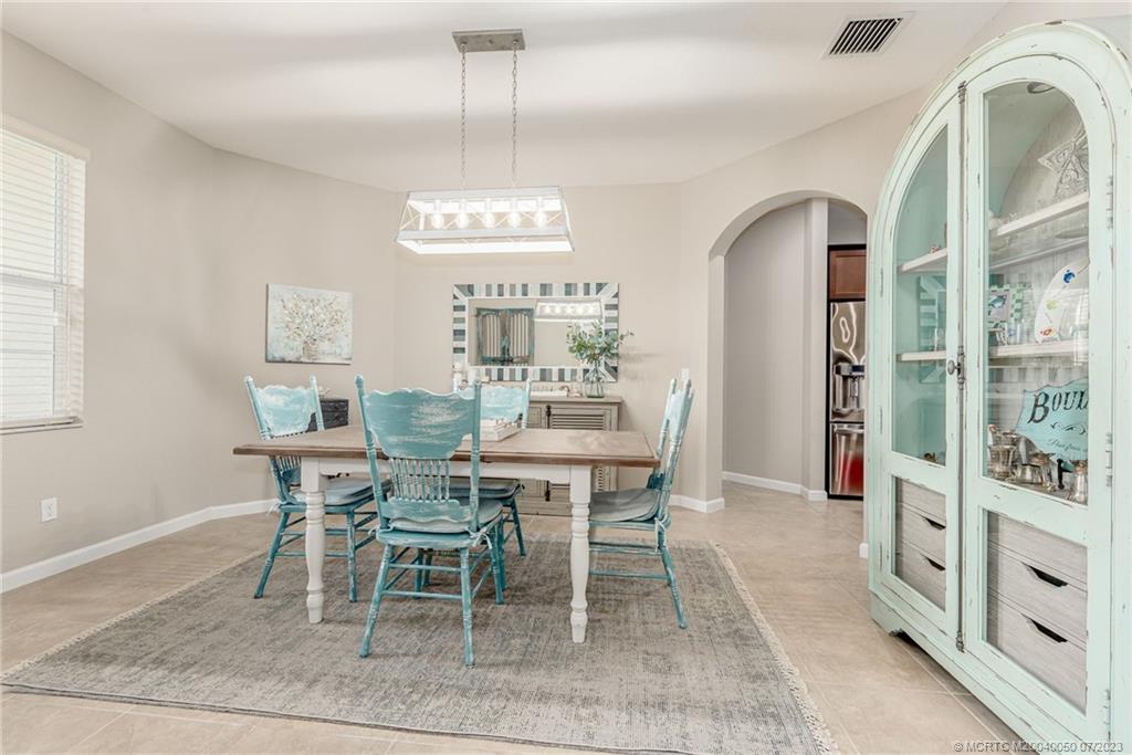 2185 Northwest Dalea Way Stuart, FL 34994 - Photo 9 of 55 a view of a dining room with furniture