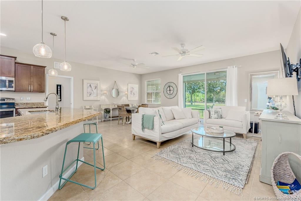 2185 Northwest Dalea Way Stuart, FL 34994 - Photo 10 of 55 a living room with furniture and a large window