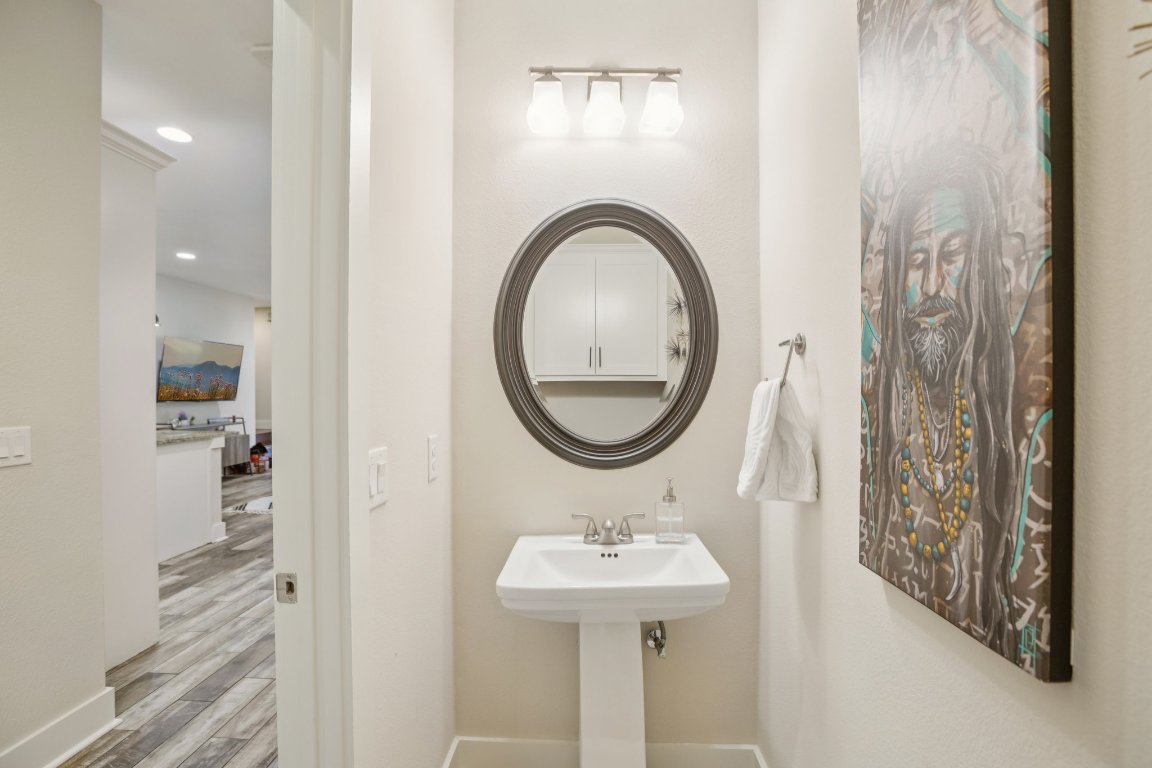 1206 Deloney Street, Unit B Austin, TX 78721 - Photo 18 of 39 Half bathroom featuring wood finished floors and recessed lighting