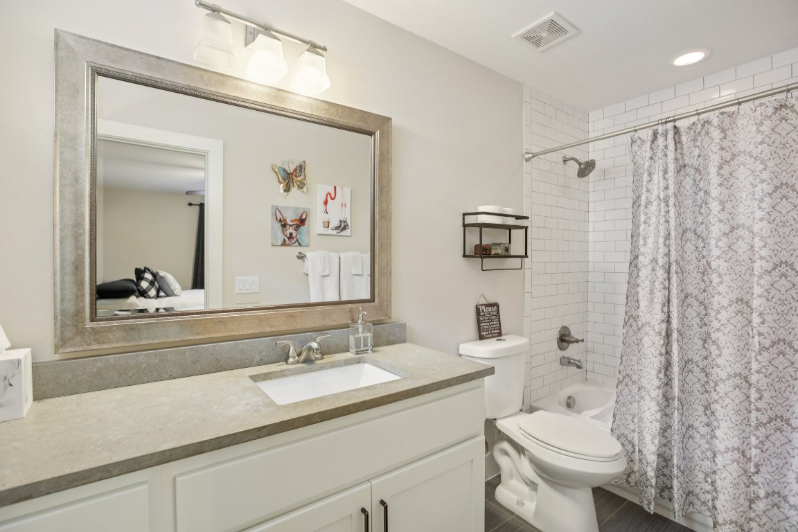 1206 Deloney Street, Unit B Austin, TX 78721 - Photo 24 of 39 Bathroom featuring vanity, shower / bathtub combination with curtain, and ensuite bath