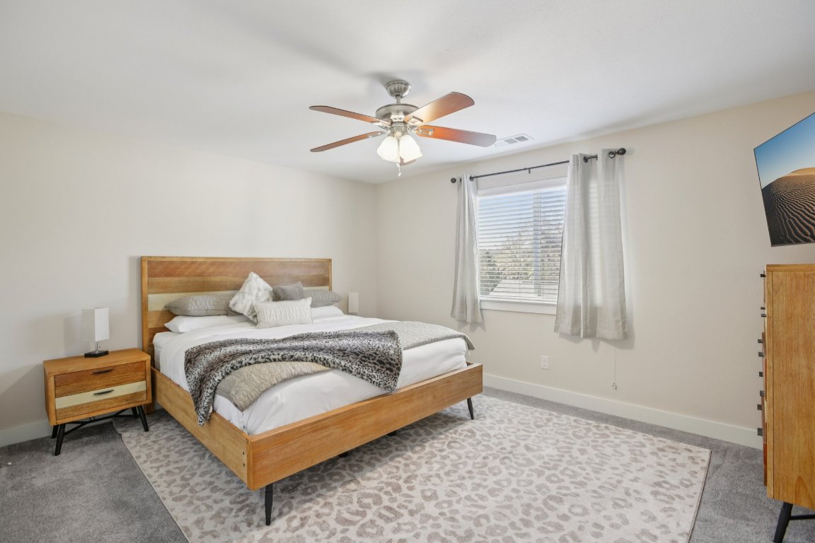 1206 Deloney Street, Unit B Austin, TX 78721 - Photo 25 of 39 Carpeted bedroom featuring baseboards and ceiling fan