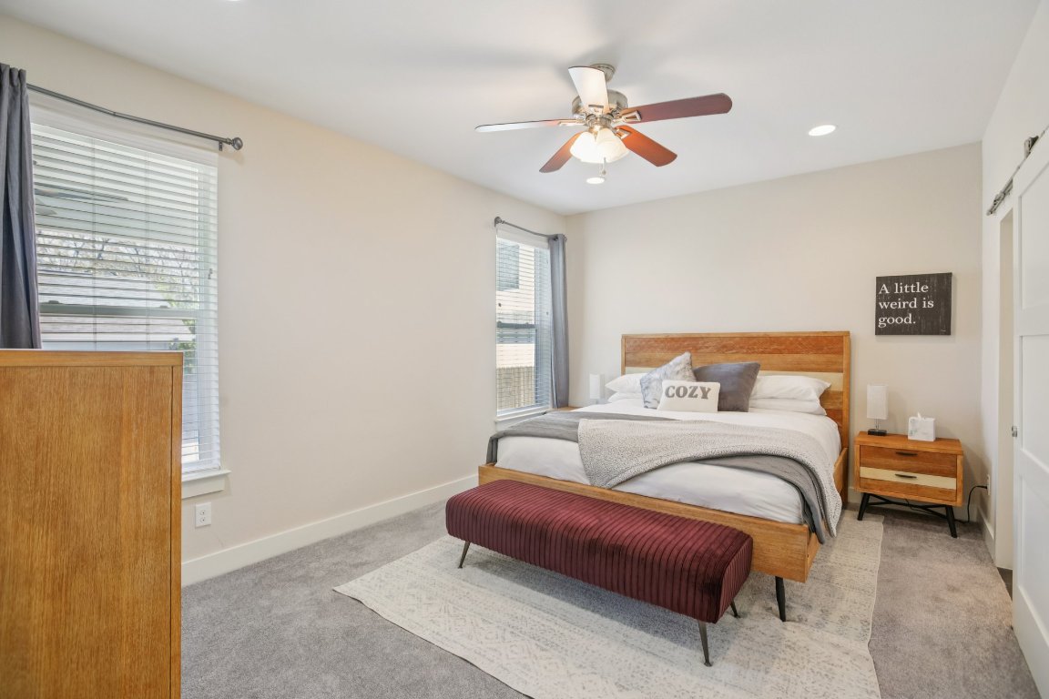 1206 Deloney Street, Unit B Austin, TX 78721 - Photo 3 of 39 Carpeted bedroom featuring ceiling fan, recessed lighting, a closet, and a barn door