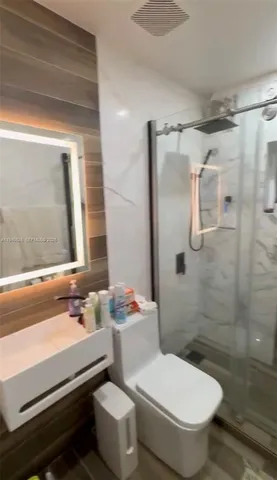 a bathroom with a sink toilet and shower