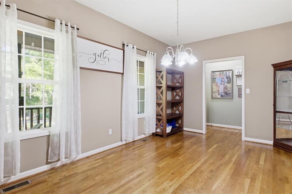 164 Laurens Road Rockmart, GA 30153 - Photo 11 of 41 a view of a room with wooden floor chandelier and windows