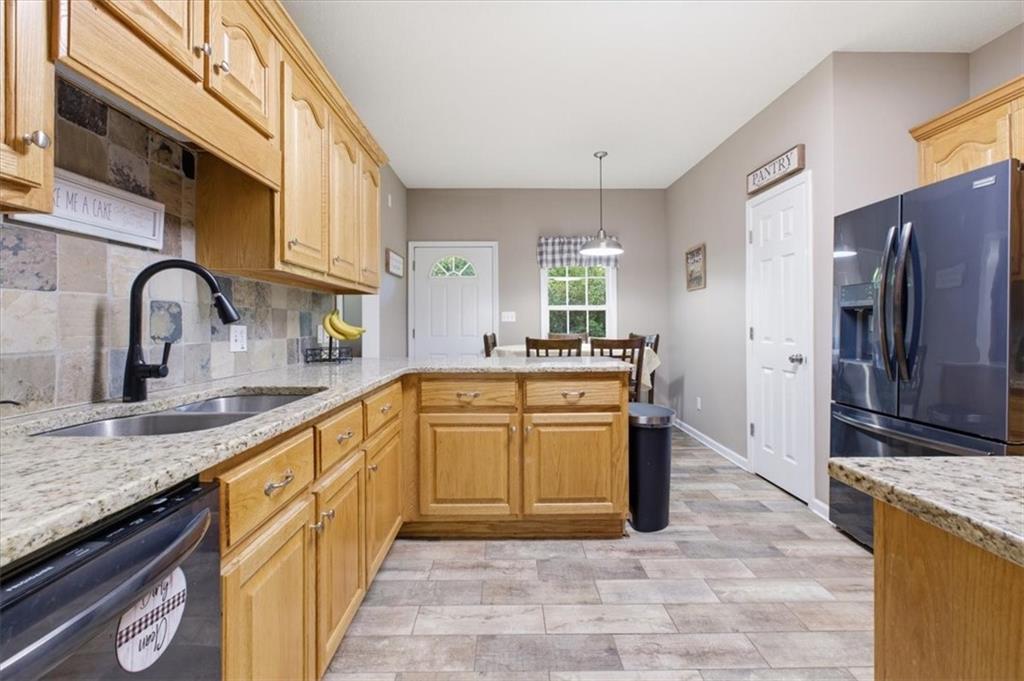 164 Laurens Road Rockmart, GA 30153 - Photo 12 of 41 a large kitchen with stainless steel appliances granite countertop a sink and cabinets